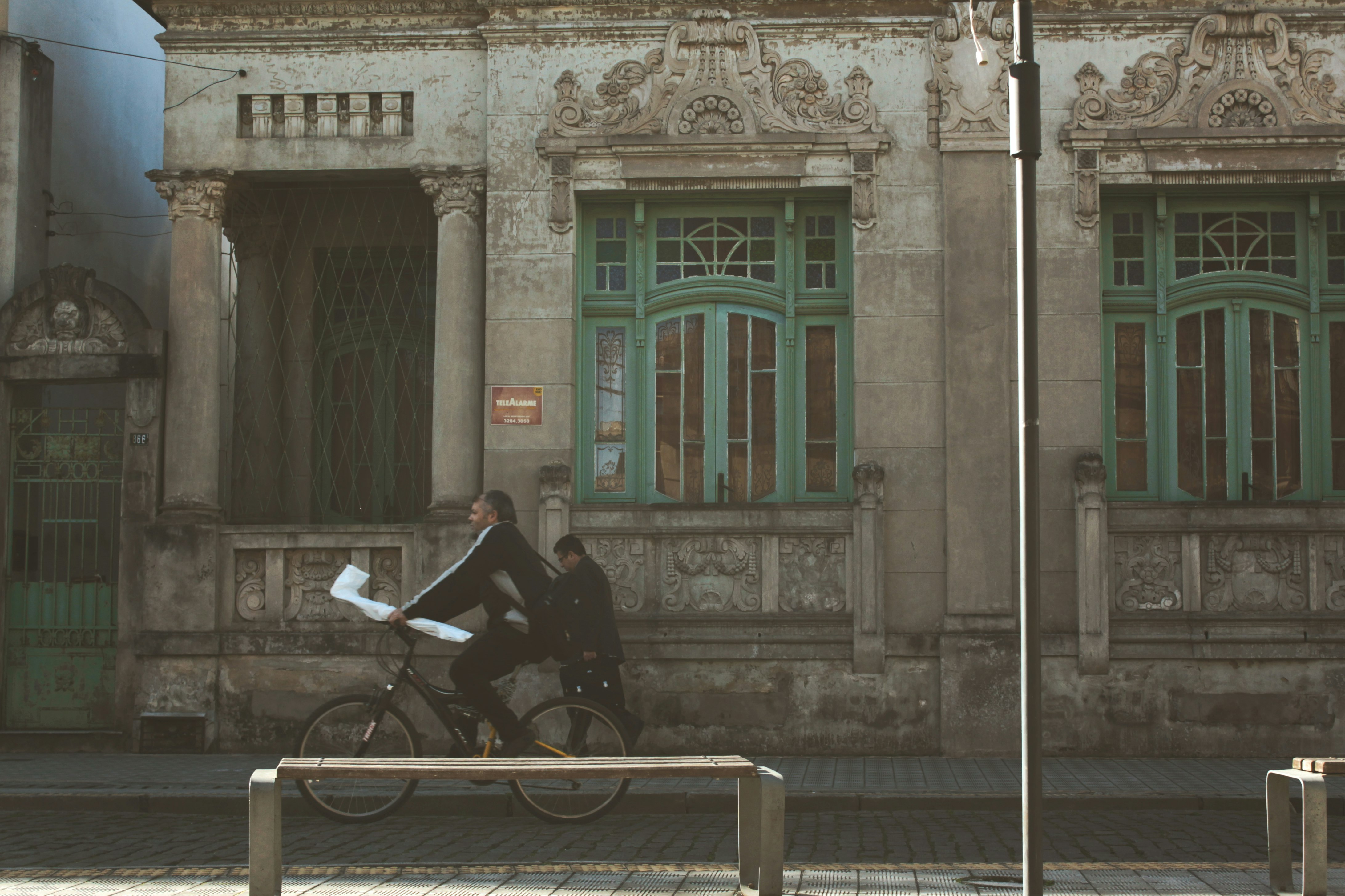 man riding bicycle on the street during daytime